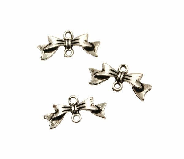 Distanziatore a forma di fiocco, con due anelli, 20x9 mm.
