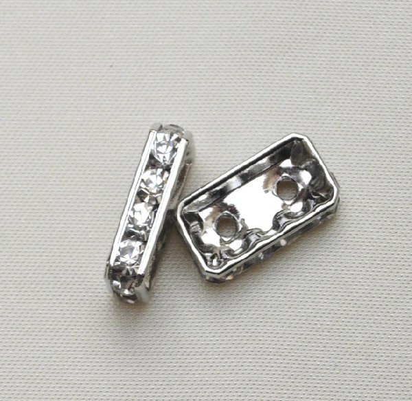 Ponte strass piatto rettangolare con 2 fori, 15x9 mm., colore strass Crystal